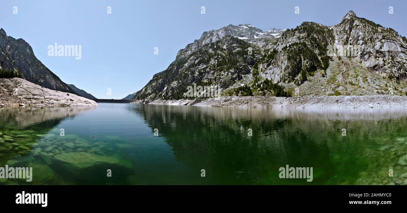 Panorama of Estany de Cavallers Lake with Crystalline transparent water seen in the dam and  Boi valley direction Pyrenees mountains of Alta Ribagorca Stock Photo