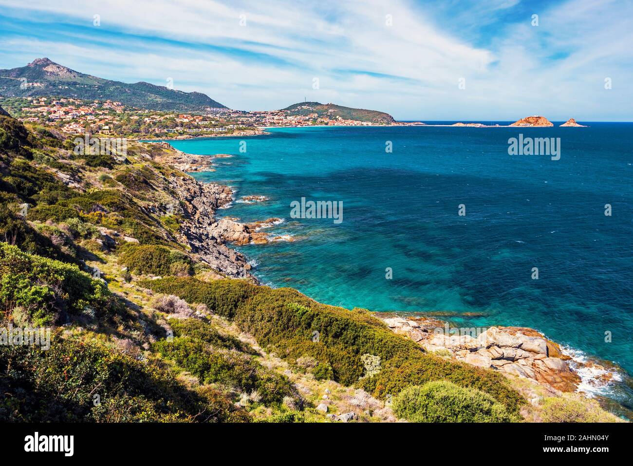 Coastline landscape in approach Ile-Rousse city in Corsica Island, seen at background with Pietra islet at right, Haute-Corse, France Stock Photo
