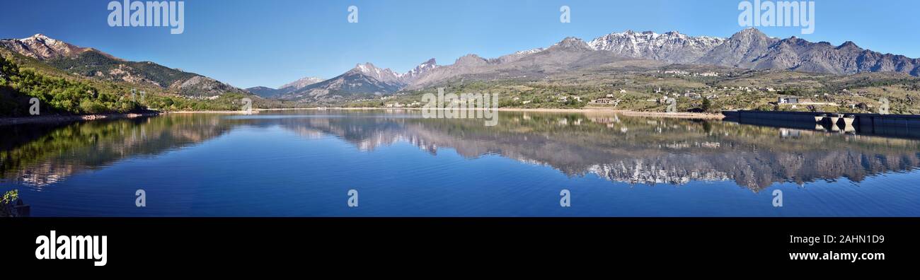 Massifs Monte Cinto at right and Monte Rotondo at left  reflecting in Calacuccia Lake in Niolo region, Golo valley in Central Corsica, Natural Regiona Stock Photo