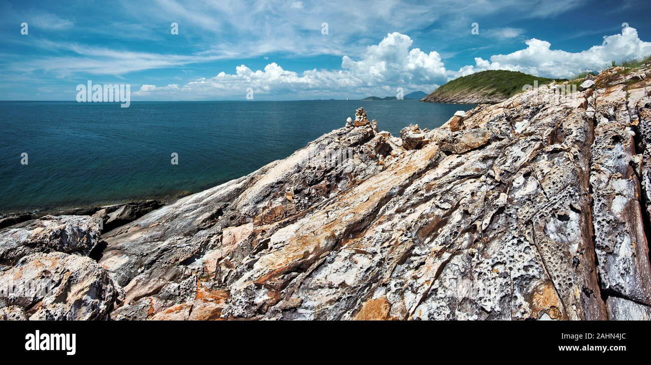 Stone texture of Wild Western coastline of Ko Samet Island and transparent water of the gulf of Thailand situated in Thai province Rayong Stock Photo