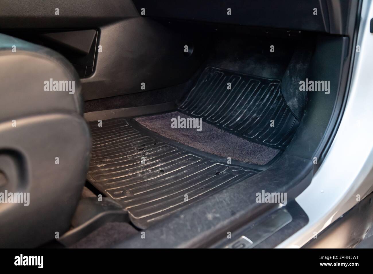 Dirty Car Floor Mats Of Black Rubber Under Passenger Seat In The