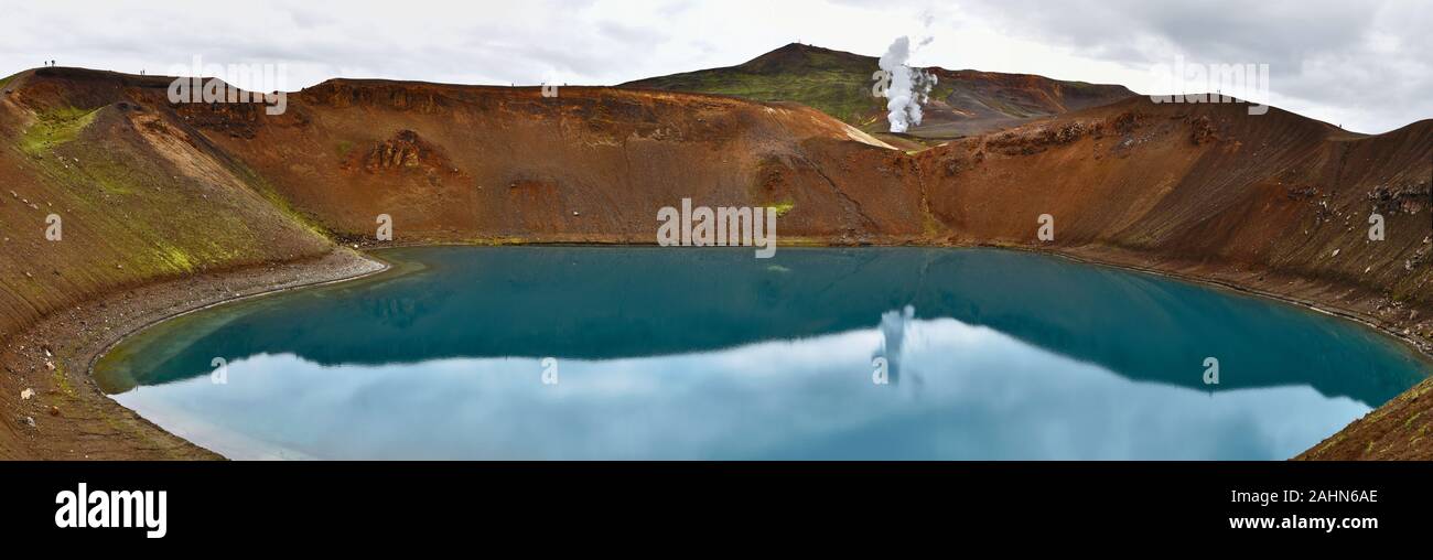Panoramic view at Krafla volcanic crater and Viti lake in northern Iceland, vapor of geothermal power plant unit is at background, Nordurland eystra r Stock Photo