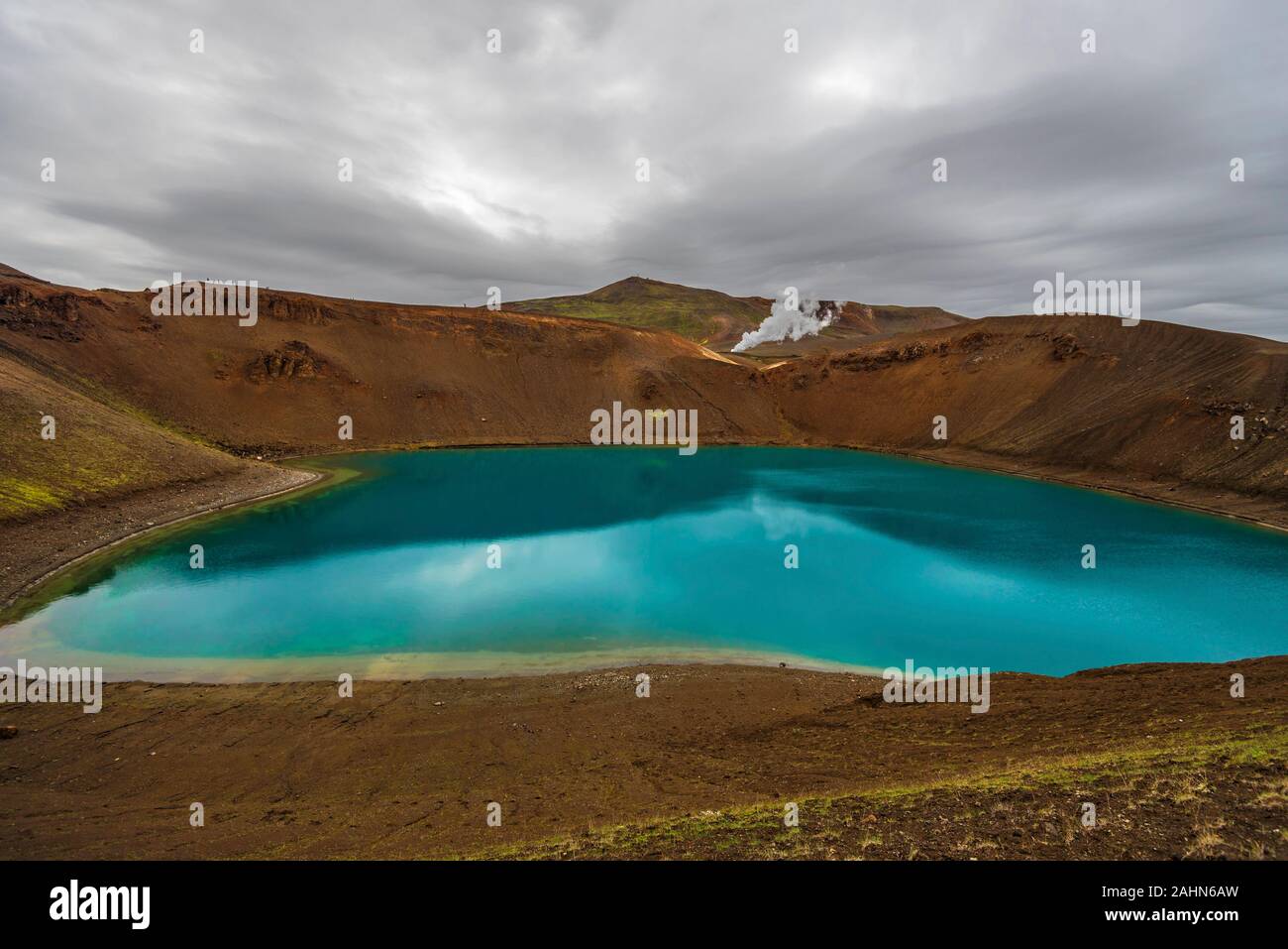View at Krafla volcanic crater and Viti lake in northern Iceland, vapor of geothermal power plant unit is at background, Nordurland eystra region. Stock Photo