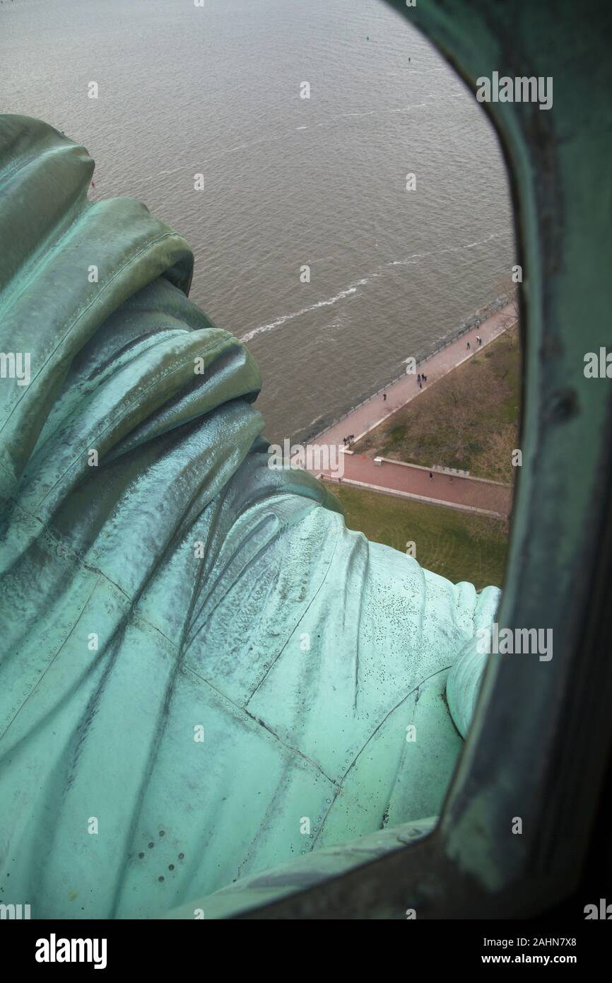 View over the right arm of the Statue of Liberty Enlightening the World from inside the crown, Liberty Island New York Harbour, New York, USA Stock Photo