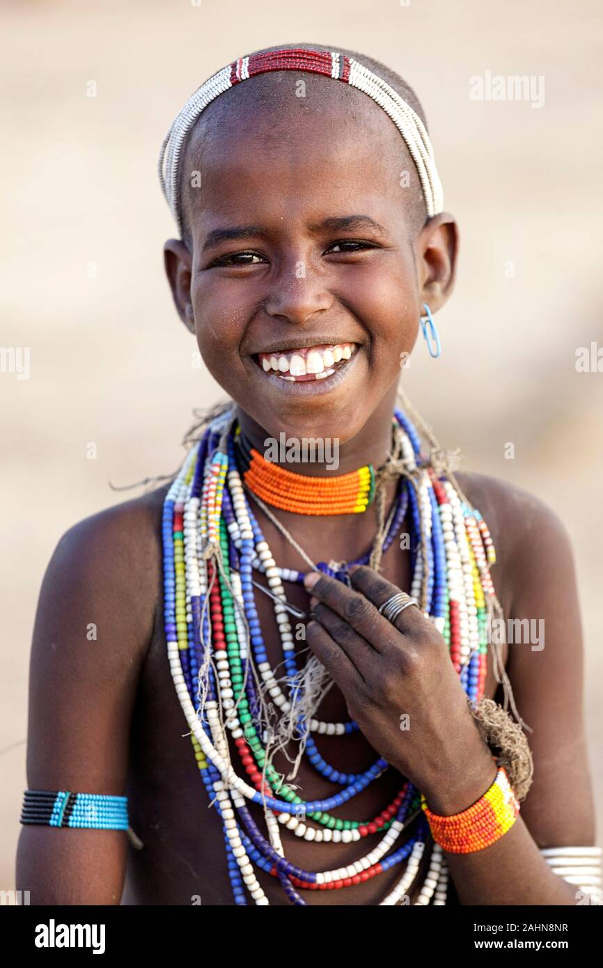 Portrait of a beautiful smiling Arbore girl touching necklaces with her hand Omo valley Ethiopia Stock Photo Alamy
