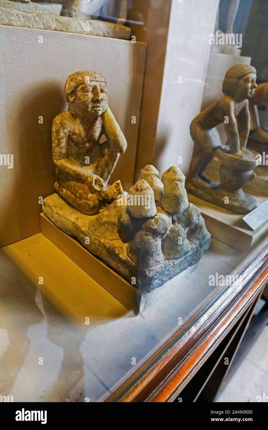 A small clay funerary model of servant figures selling bread on display