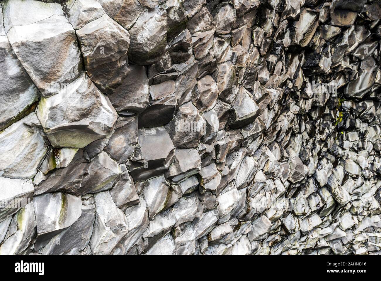 Perspective view of Basalt cliffs pattern inside the cave in the bottom of Reynisfjall mountain in Southern Iceland. Stock Photo
