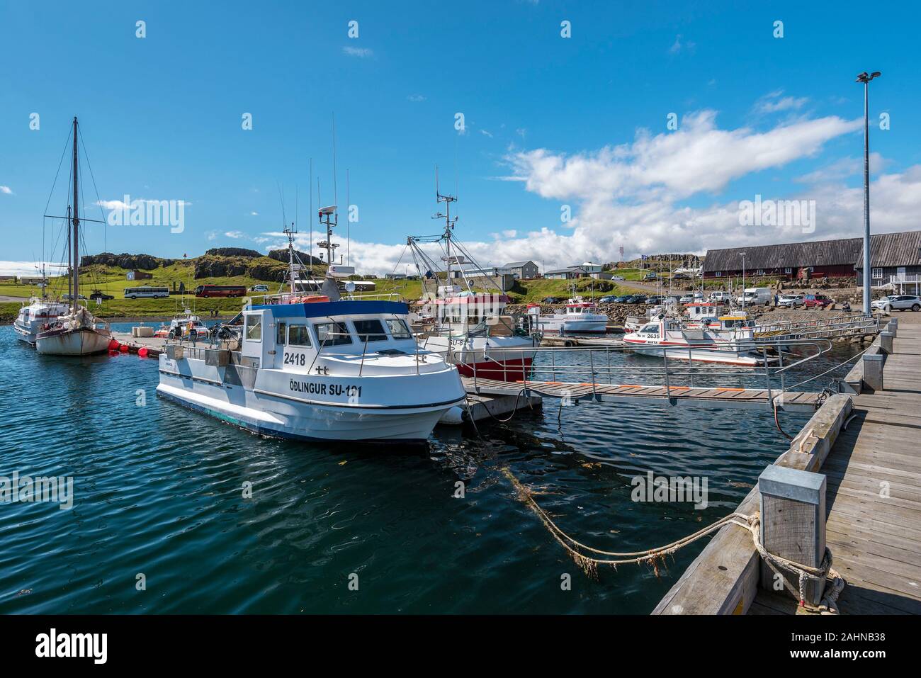 Djupivogur, Iceland – 25 July, 2018   Harbor of Djupivogur town Viewed from floating jetty in the Austurland in eastern Iceland. Buildings of the town Stock Photo