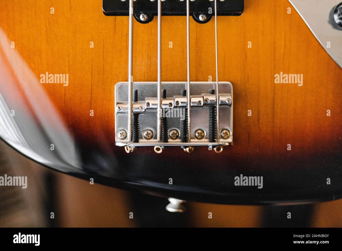 fender jazz bass bridge saddles top down with blurry background Stock Photo  - Alamy