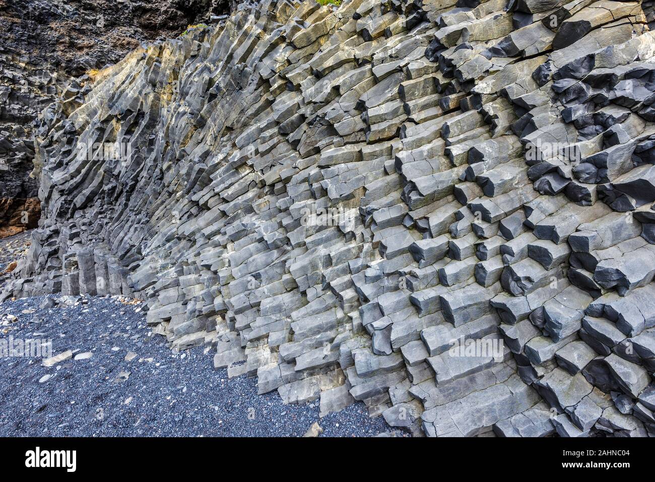 Hexagonal basalt cliffs of the bottom of Reynisfjall mountain in
