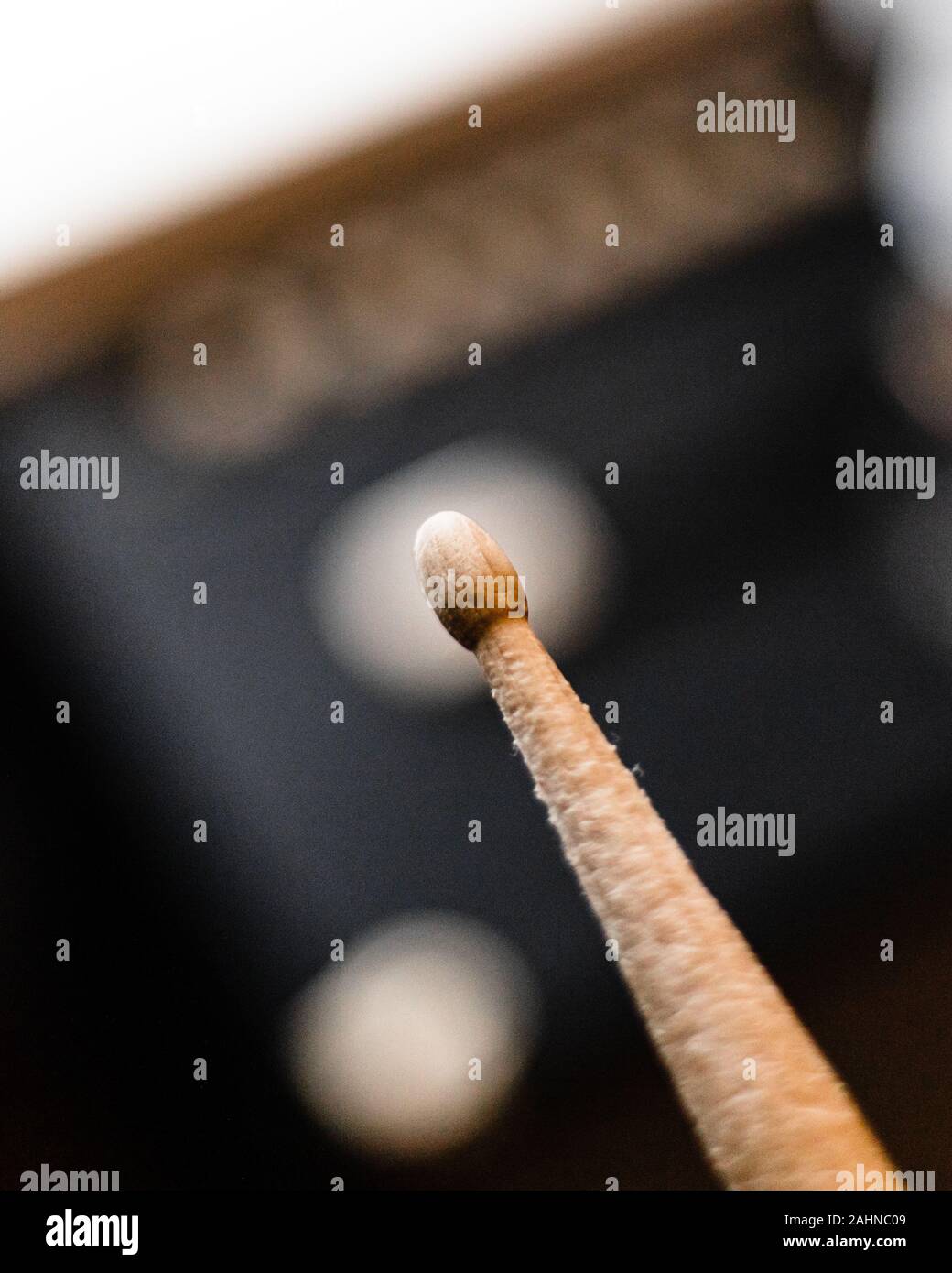 close up of worn used drum stick with blurry background Stock Photo