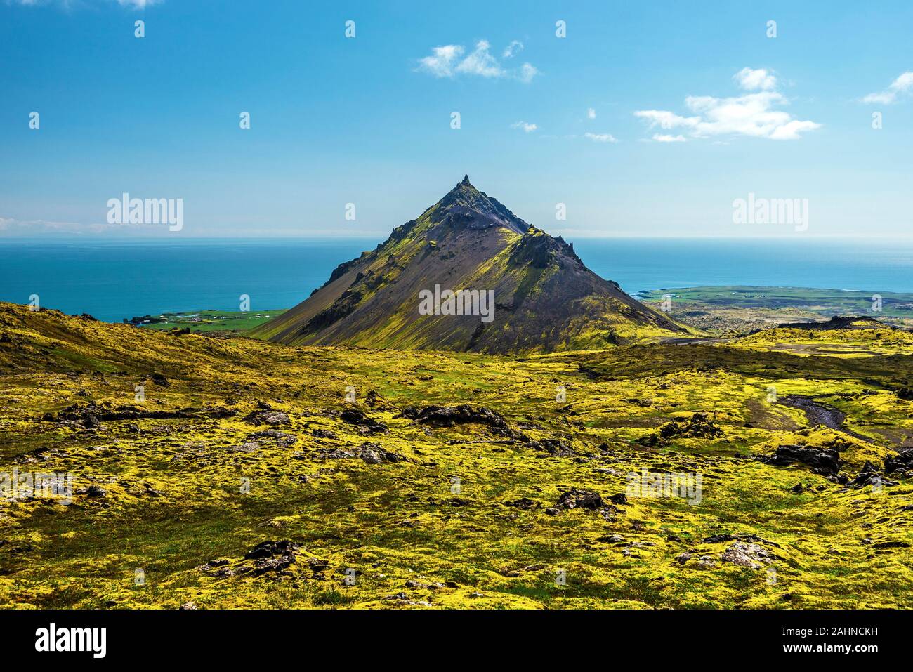View at Stapafell mountain from the southern slope of Snaefellsjokull mountain on Snaefellsnes peninsula in Western Iceland. Waters of Faxa Bay are at Stock Photo