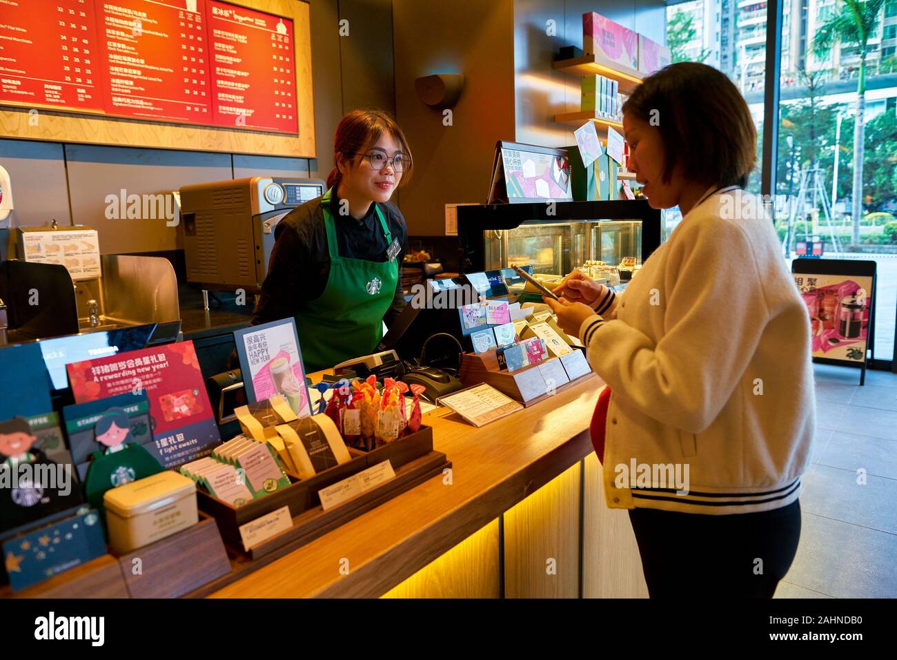 SHENZHEN, CHINA - CIRCA JANUARY 2019: woman buying coffee at