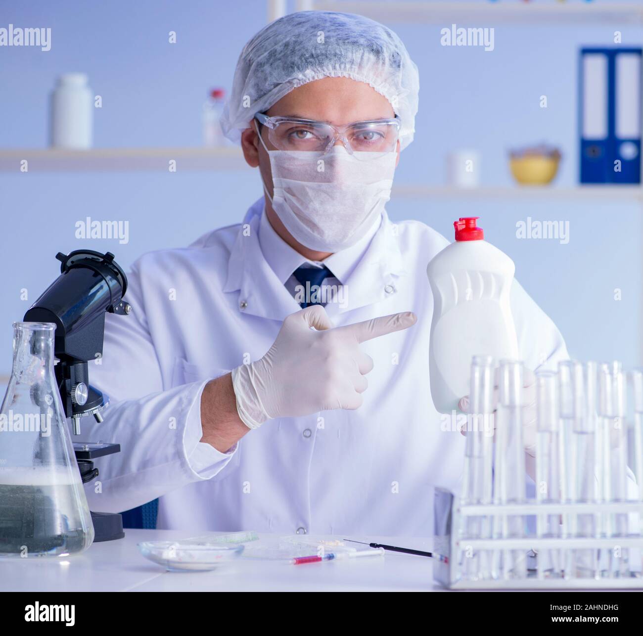The man in the lab testing new cleaning solution detergent Stock Photo