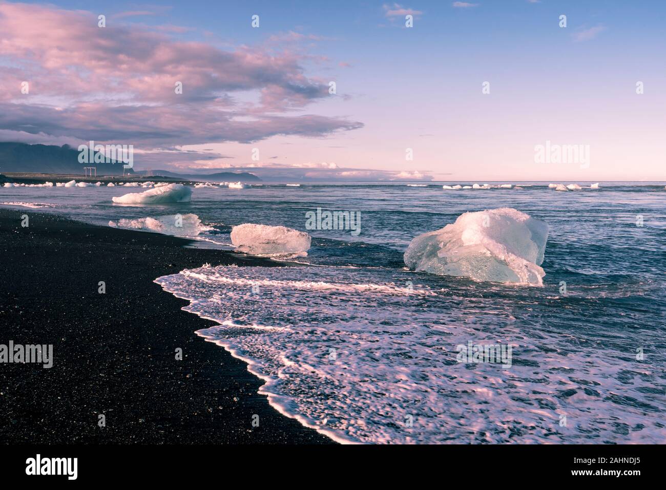 Small icebergs drifting from , Jokulsarlon glacier lagoon to Atlantic Ocean in Southeastern Iceland. Stock Photo