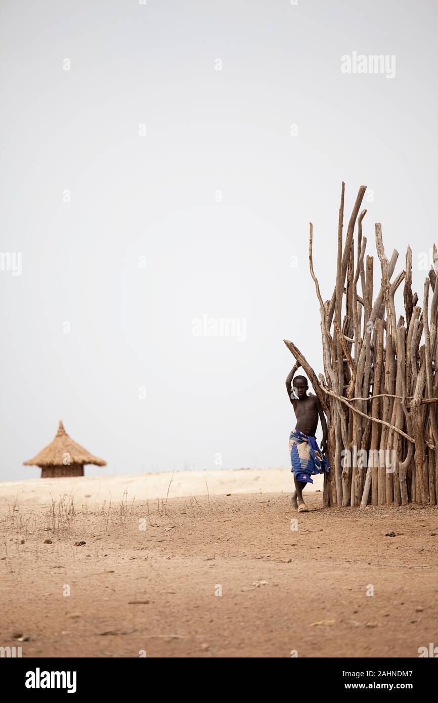 Karo tribe, Young tribal Suri boy in the desert, Omo valley, Ethiopia, Africa Stock Photo