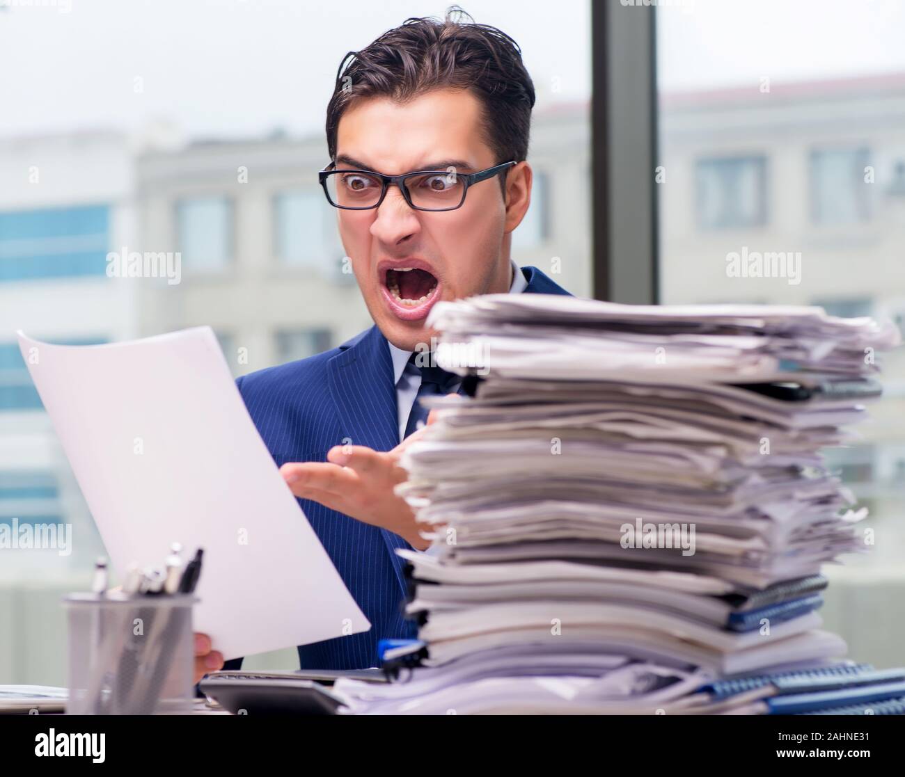 The workaholic businessman overworked with too much work in office