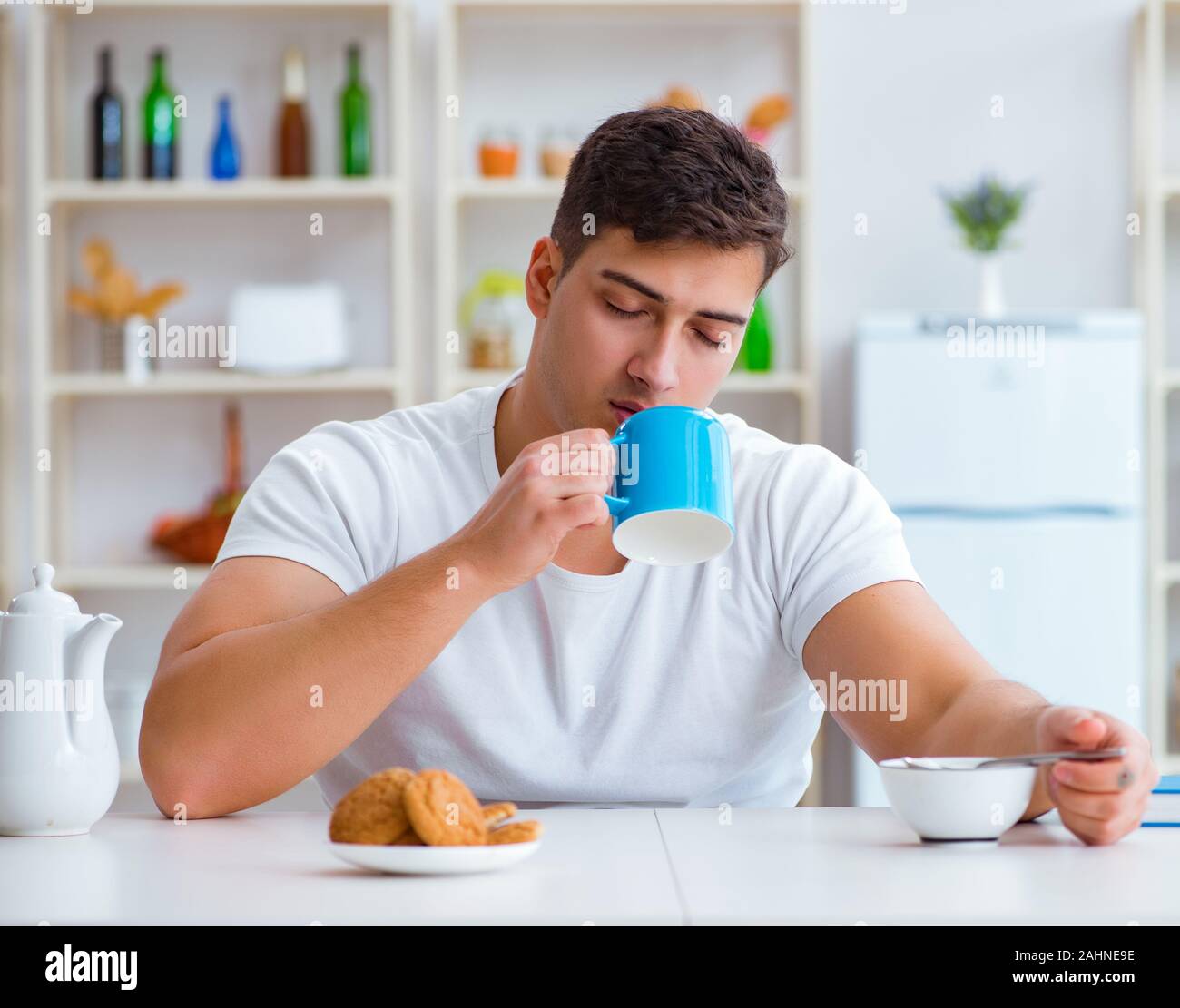 The man falling asleep during his breakfast after overtime work Stock Photo