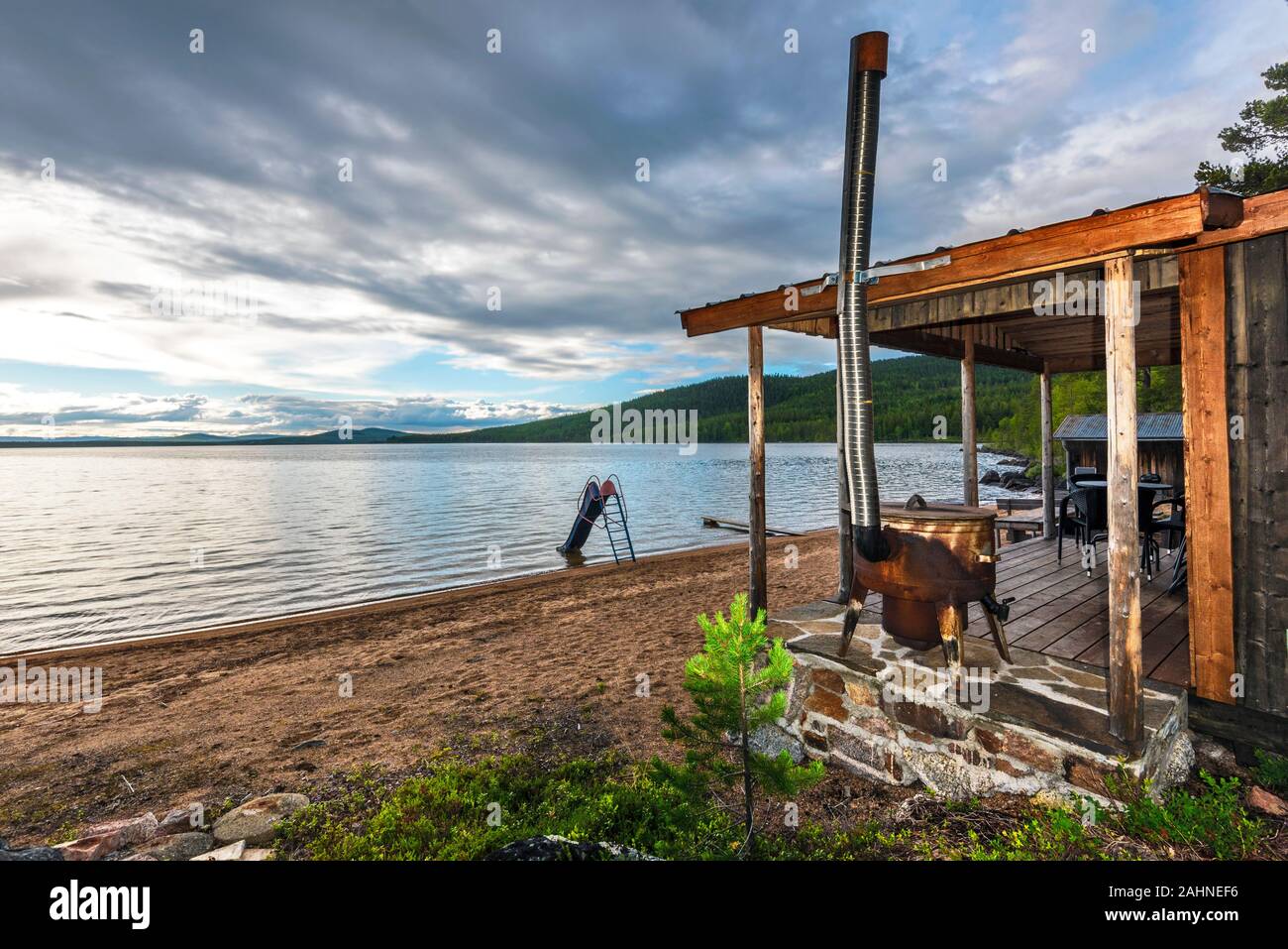 Terrace of the Wooden house with wood stove for heating in the border of Sandsjon lake in Swedish Lapland. Vasterbotten county, Norrland, Sweden. Stock Photo