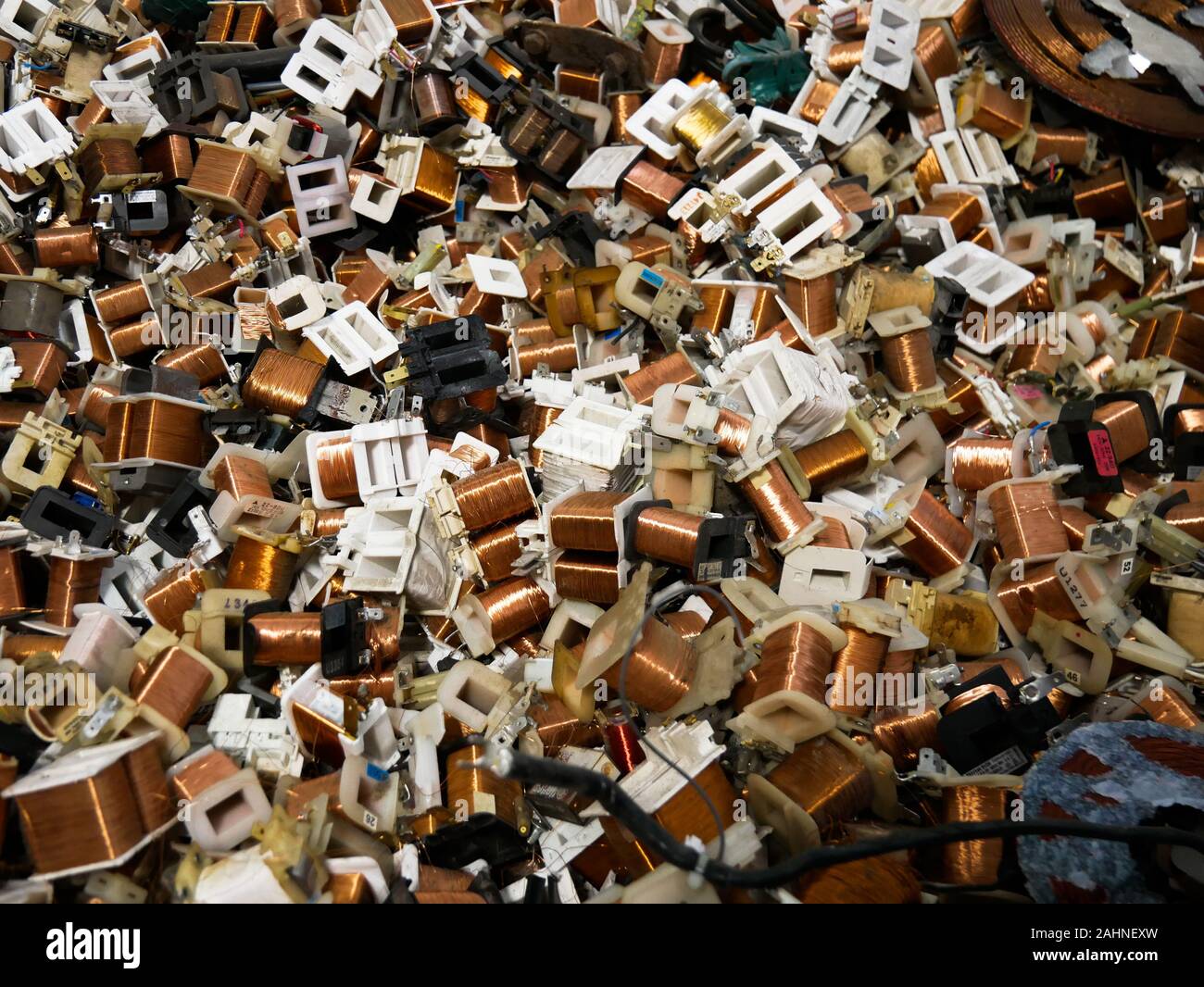 Wien/Austria - june 4 2019: pile of cooper coil inductors used on microwaves ovens  in a recycling and recovery compound in vienna Stock Photo