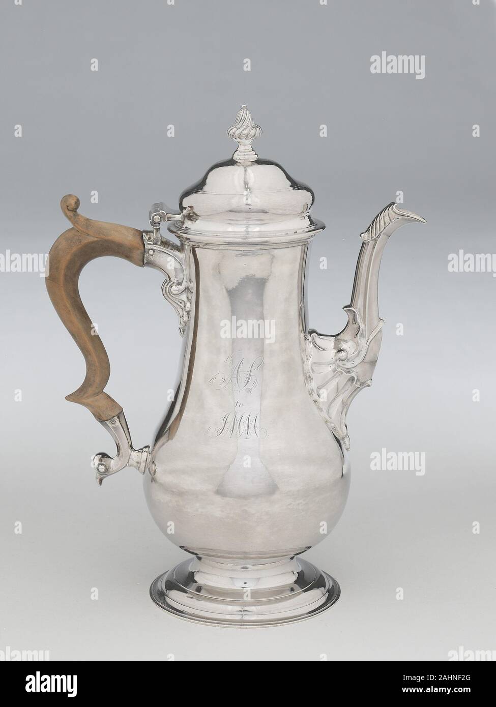 Joseph Richardson, Sr.. Coffeepot. 1770. Philadelphia. Silver Because it was a costly import, coffee was not a popular beverage in early colonial America. Increased trade between the American colonies, South America, and the West Indies made coffee an accessible staple by the middle of the 18th century. Although the form of this single-bellied coffeepot suggests it was made at an earlier date, its broken scroll handle, double-domed cover, and leaf-and-shell decoration place this object firmly within the high Rococo period. Stock Photo