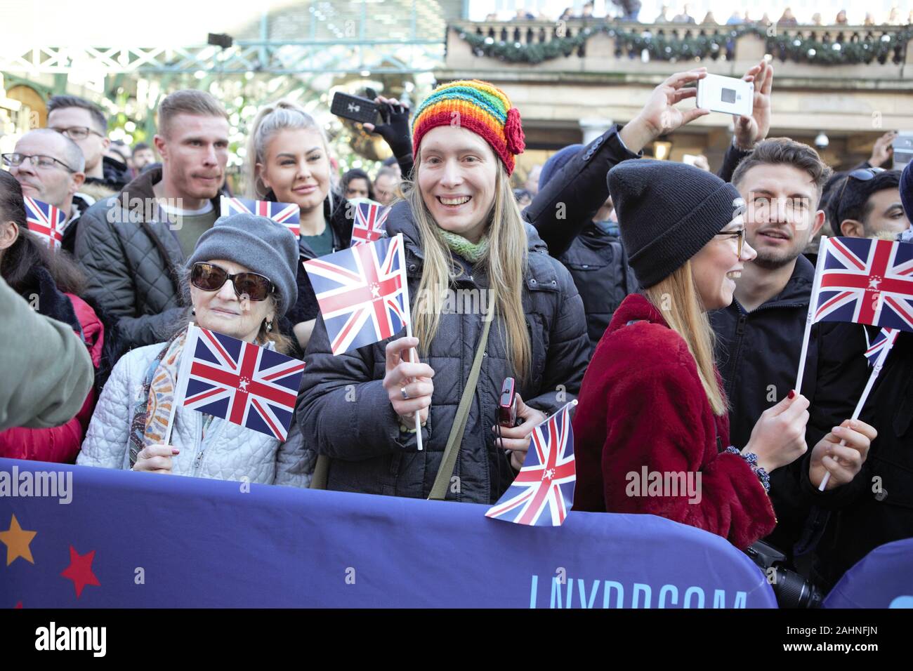 London, UK. 30th Dec, 2019. Spectators holding UK Flags during London's New Year's Day Parade (LNYDP) 2020 Preview Show at Covent Garden Piazza. Credit: Pietro Recchia/SOPA Images/ZUMA Wire/Alamy Live News Stock Photo