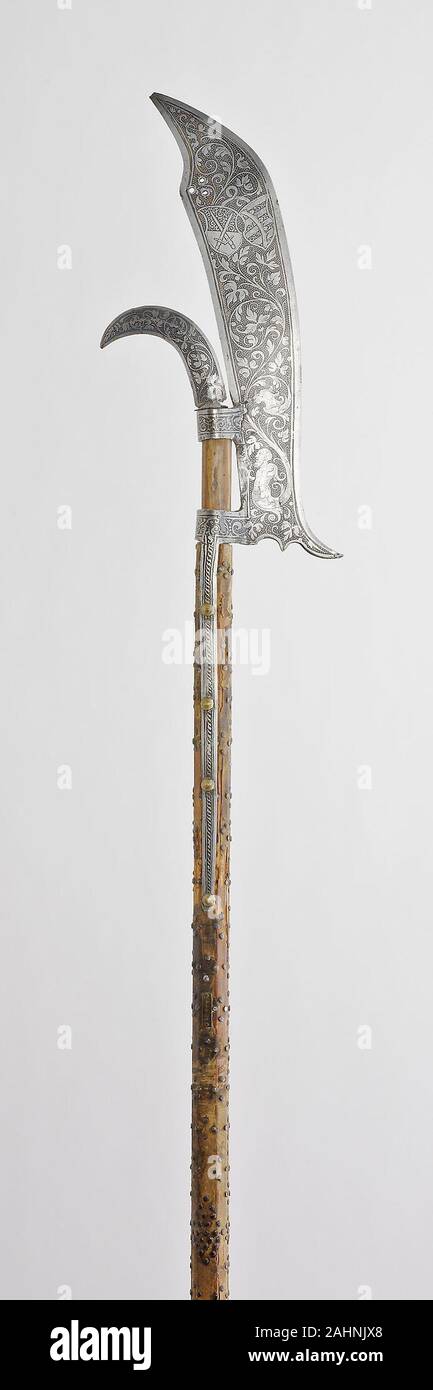Glaive of the Bodyguard of August I, Elector of Saxony. 1575–1585. Saxony. Steel, brass, wood, and silk textie Pole arms (staff weapons) were used not only in warfare and hunting, but also in sporting combat and ceremonies. The term refers to a family of edged weapons attached to wooden staffs. With the exception of the lance, which remained the weapon of the mounted knight, all other staff weapons were wielded by men on foot by 1600. With the development of firearms and their introduction as infantry weapons, pole arms lost their importance on the field, and from the mid-16th century, they we Stock Photo