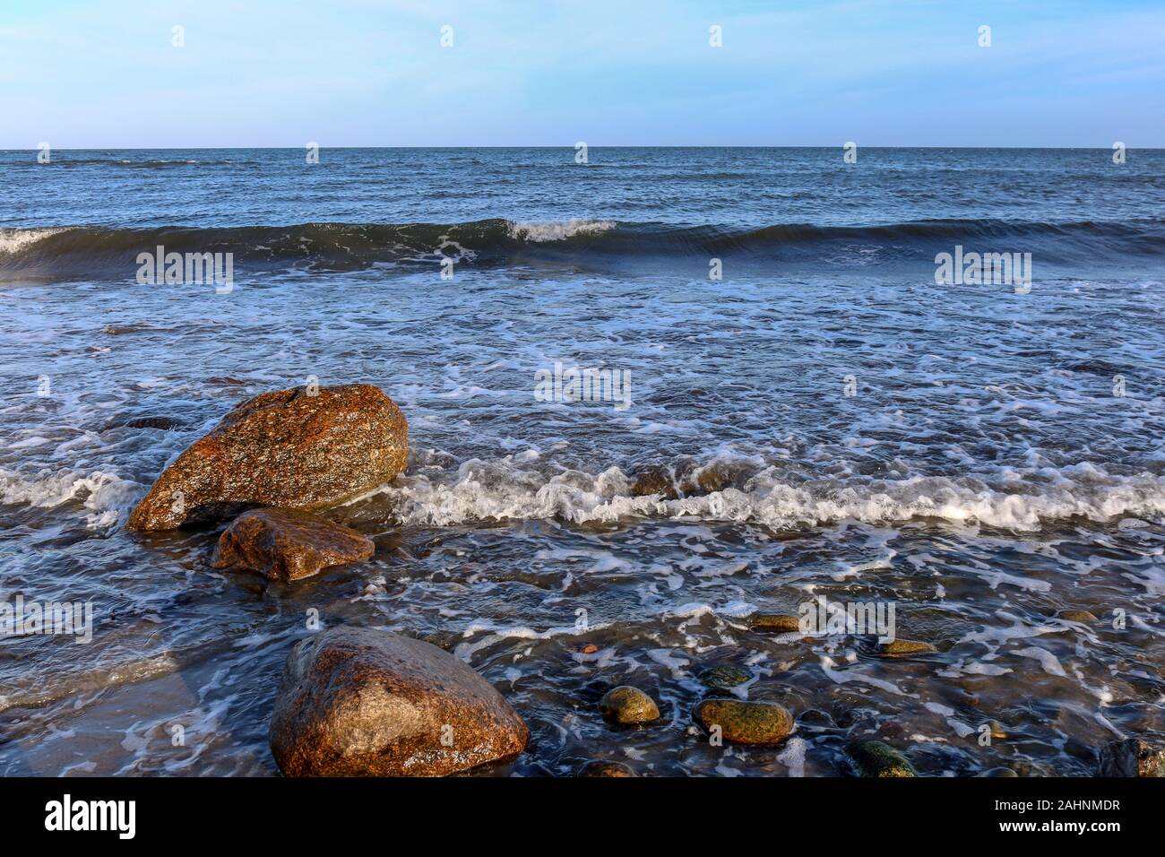 Waves break on the stones on the Baltic Sea beaches near Hohwacht, Germany Stock Photo