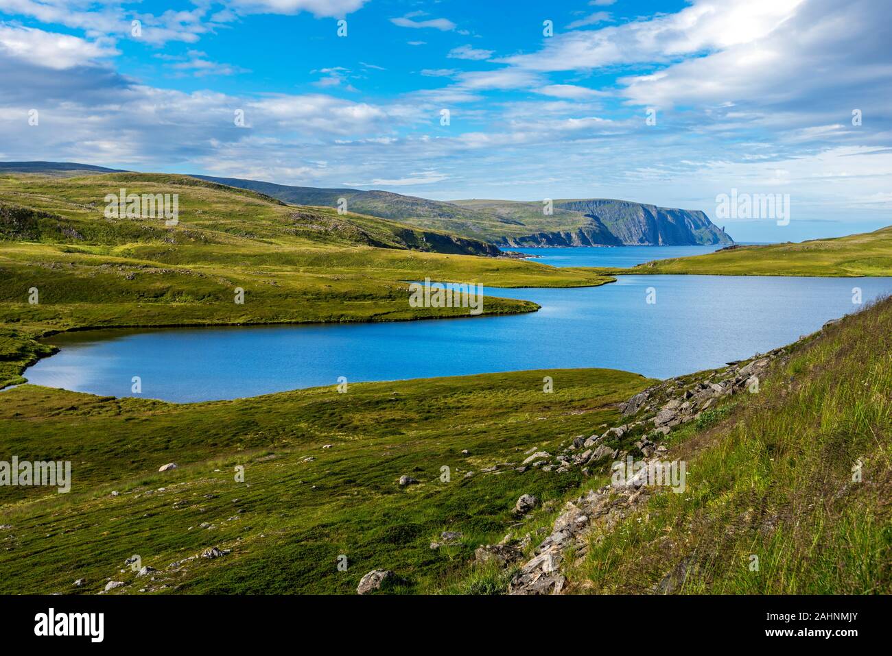 Storvatnet lake in Mageroya island. The coastline of the Barents Sea in Nord Cape direction is at background. Nordkapp Municipality in Norwegian Finnm Stock Photo
