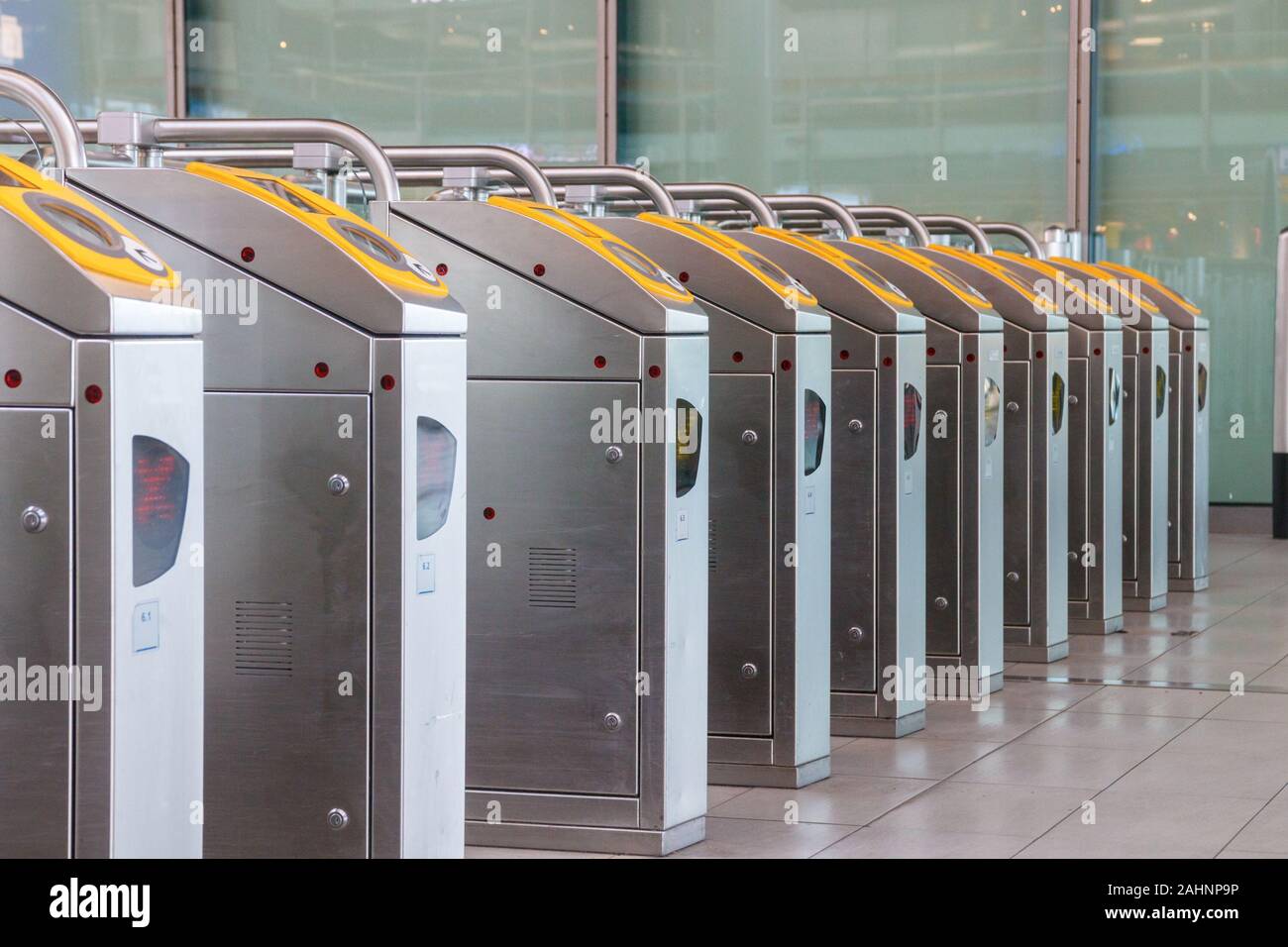 Line of electronic ticket barriers in the Utrecht Centraal Station hall. Passengers can use a chip card for contactless checking in and out. Utrecht, Stock Photo