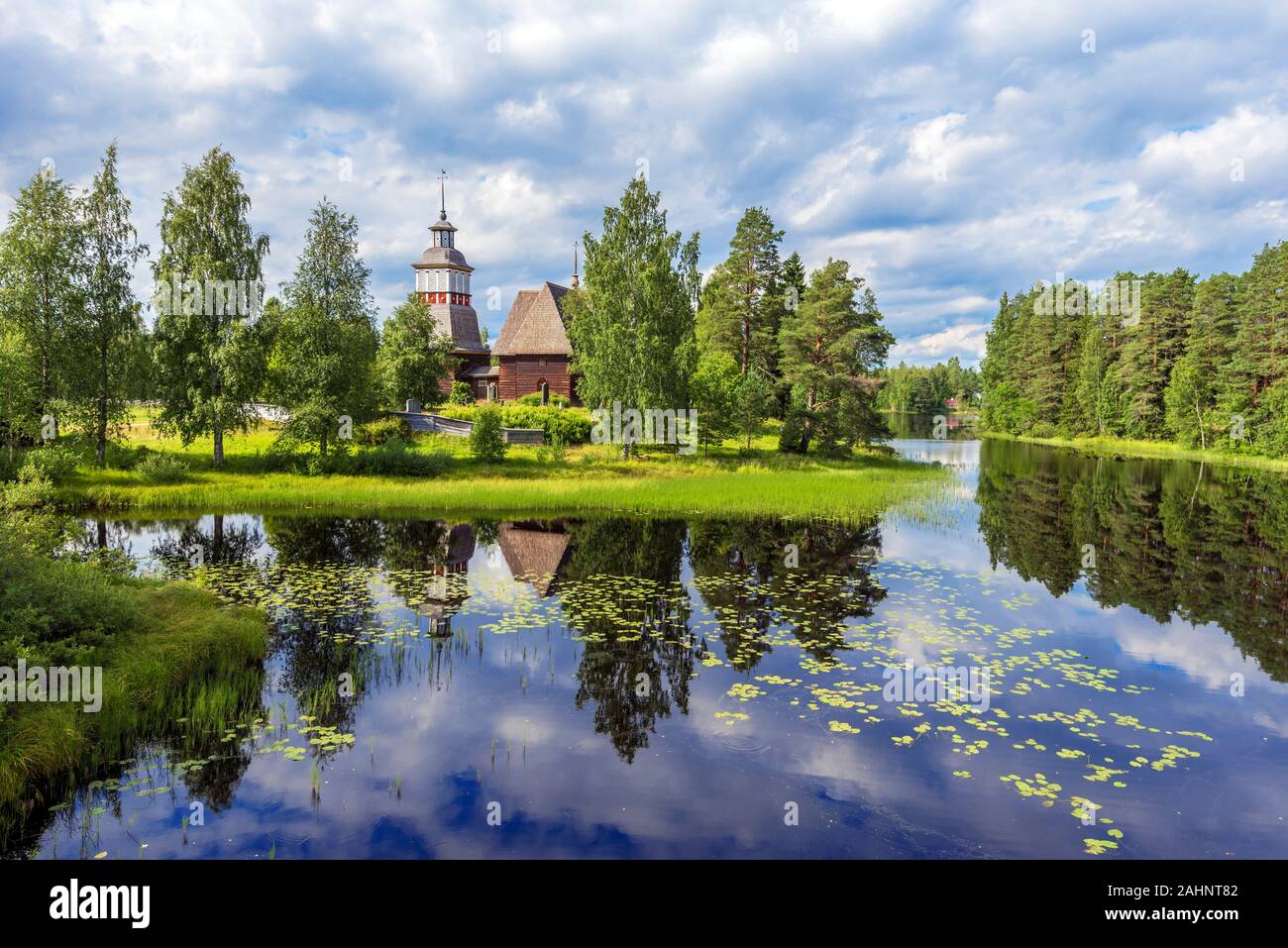 Old wooden church of Petajavesi village is a part of natural environment of lake and forests. Jyvaskyla region in Central Finland. Stock Photo