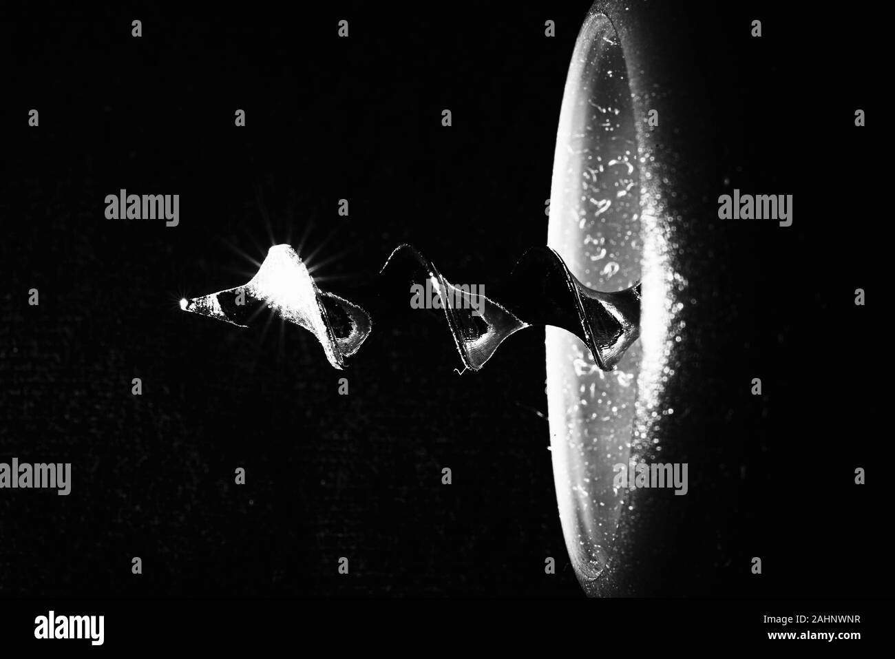 details of a corkscrew on a black background macro photography Stock
