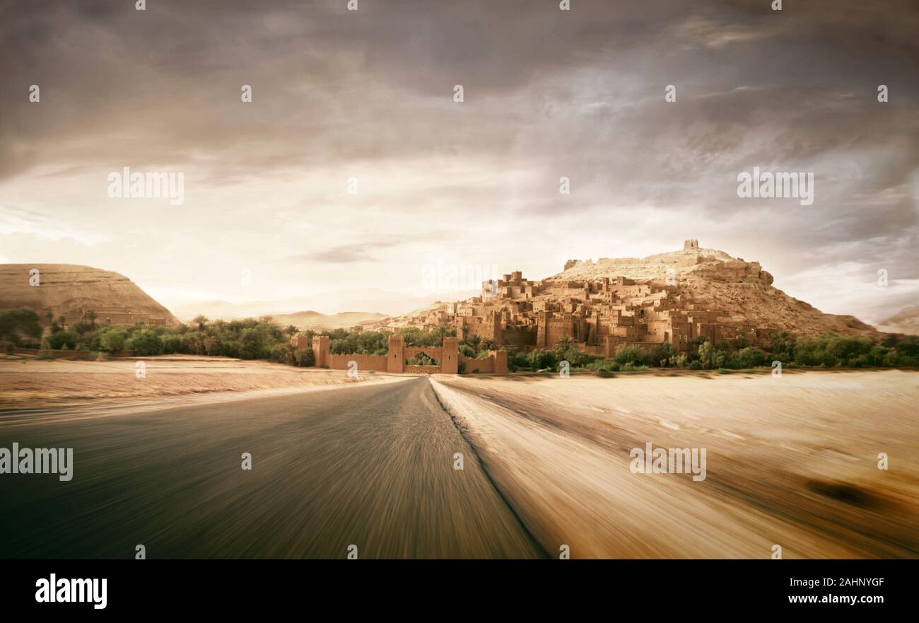 Front view of a car speeding on a deserted road. Stock Photo