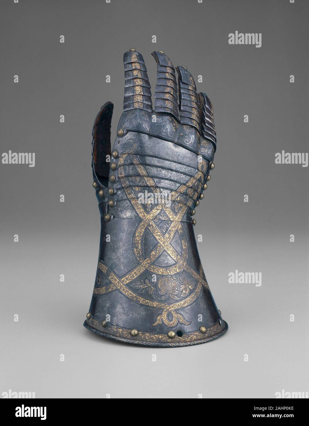 Anton Peffenhauser. Gauntlet from a Tournament Garniture of a Hapsburg Prince. 1560–1590. Augsburg. Steel, gilding, brass, and leather Stock Photo
