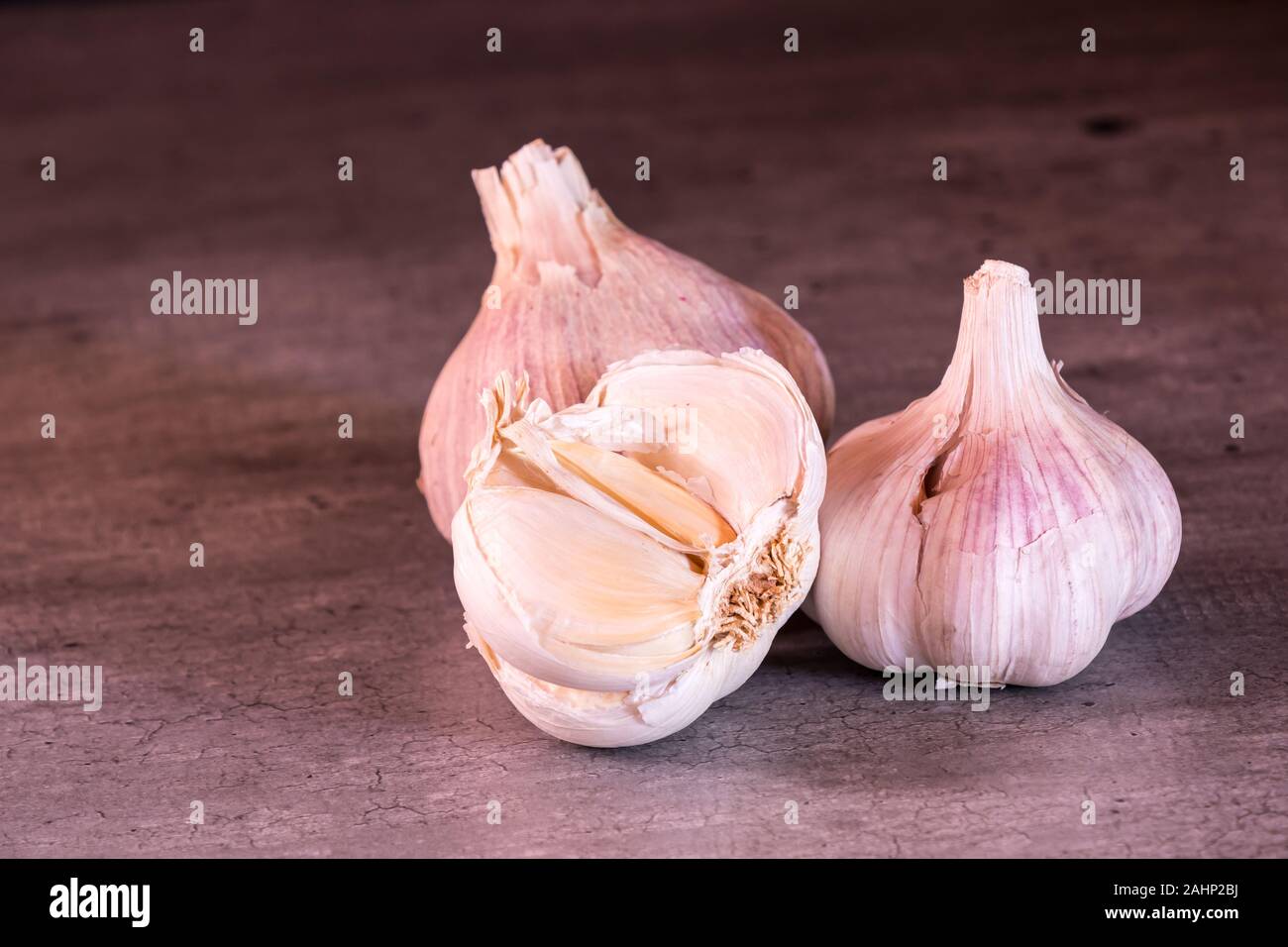 three large heads of pink garlic on a kitchen worktop Stock Photo Alamy