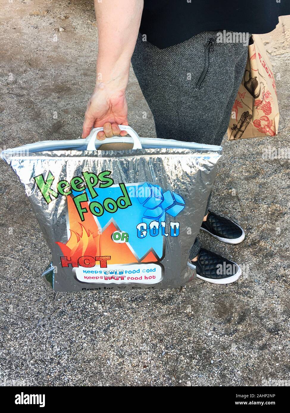 Woman carrying a reusable bag that keeps food either cool or hot in Tucson AZ Stock Photo Alamy