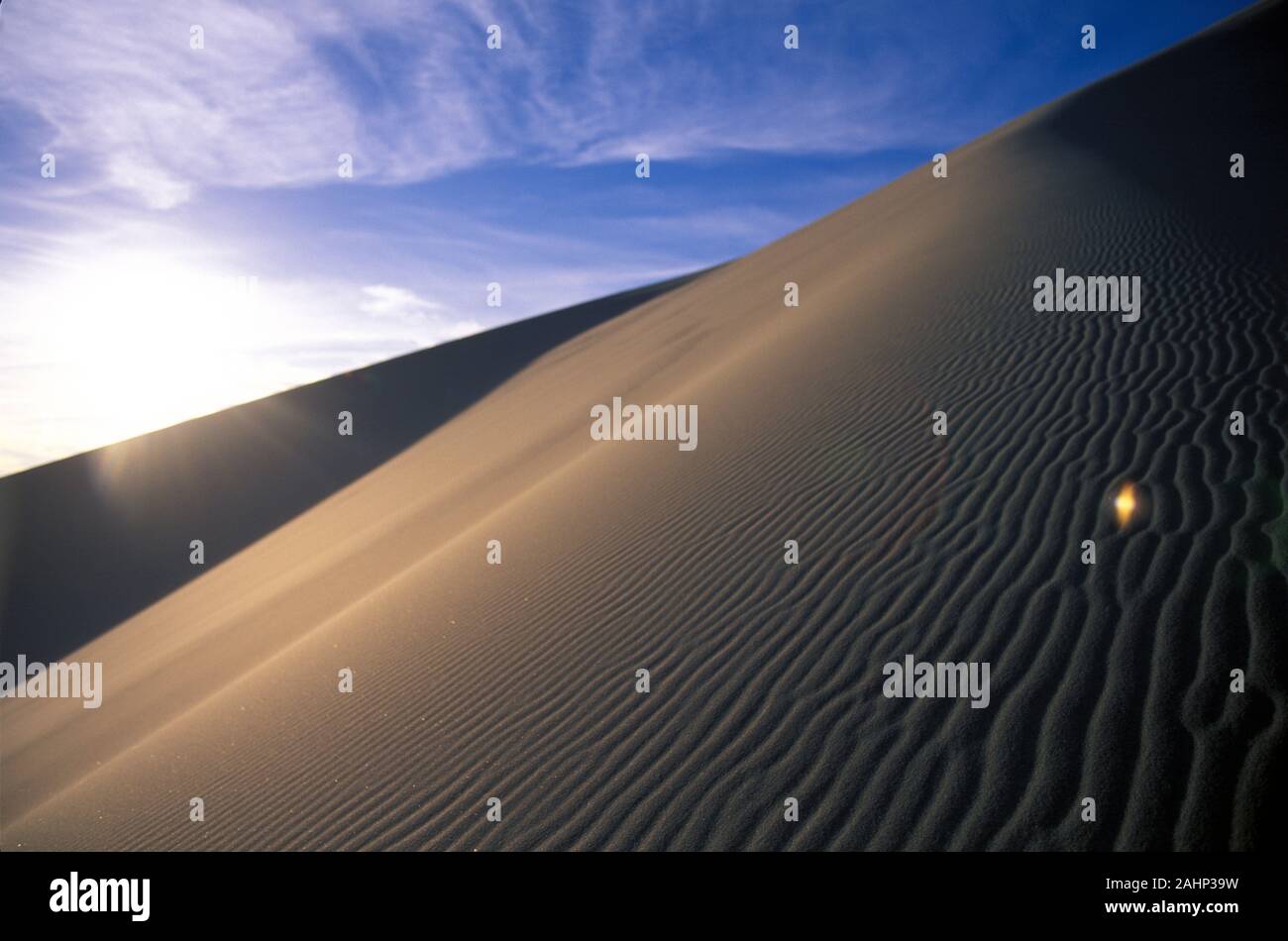 The sun sets over a sand dune Stock Photo