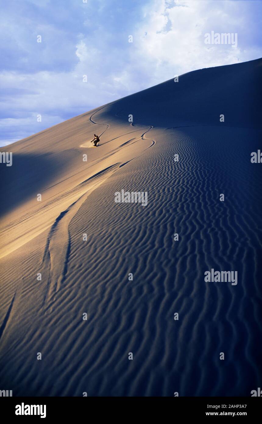 Sandboarding on Nevada dune Stock Photo Alamy