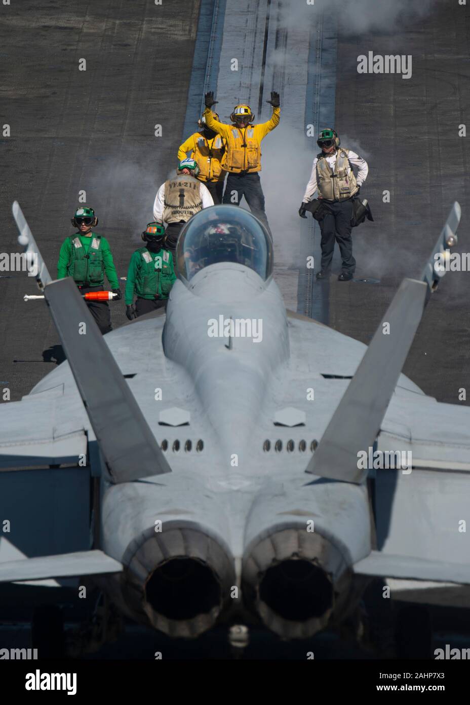 U.S. Navy Sailors align an F/A-18F Super Hornet fighter aircraft attached to the Fighting Checkmates of Strike Fighter Squadron 211 with a catapult on the flight deck  Nimitz-class aircraft carrier USS Harry S. Truman December 24, 2019 into the Arabian Sea. Stock Photo