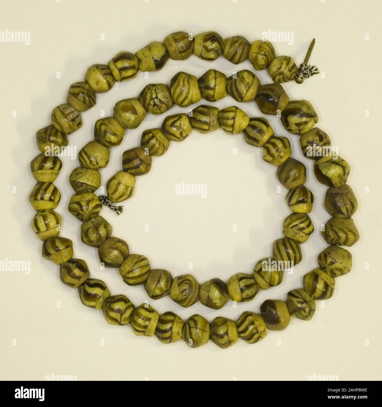 Ancient Roman. String of Beads. 301 AD–500 AD. Egypt. Glass Perhaps used  for personal adornment or decoration within the home, these beads are  individually patterned with black stripes. It is possible that