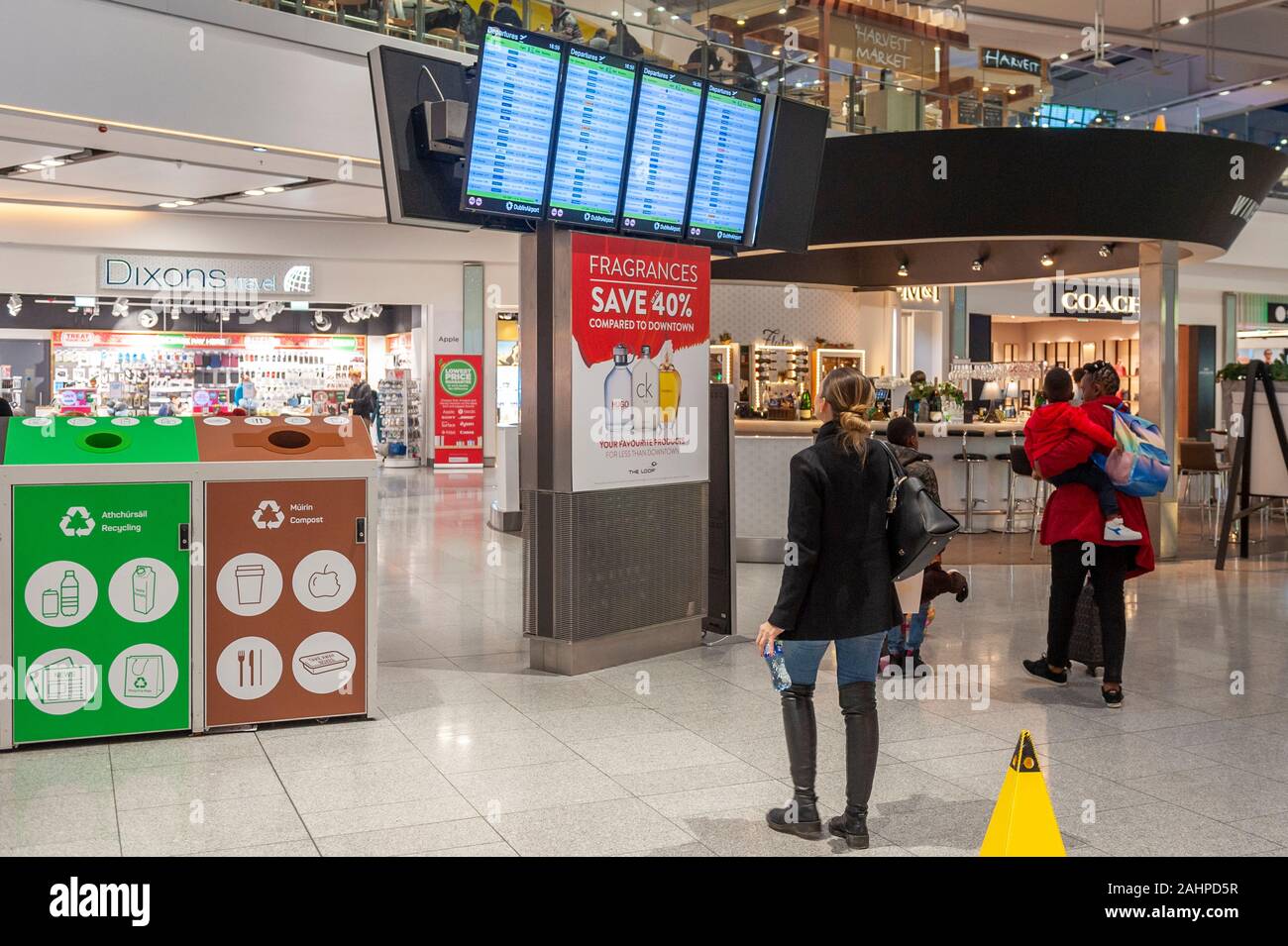Passengers look at the departures boards in Terminal 2, Dublin Airport, Dublin, Ireland. Stock Photo