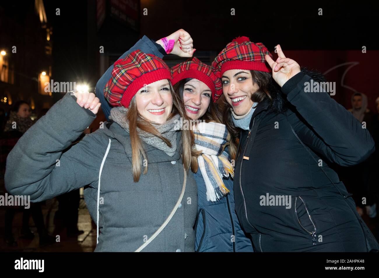 Revellers from Italy enjoy the street party on Princes Street during the Hogmanay New Year celebrations in Edinburgh. Stock Photo