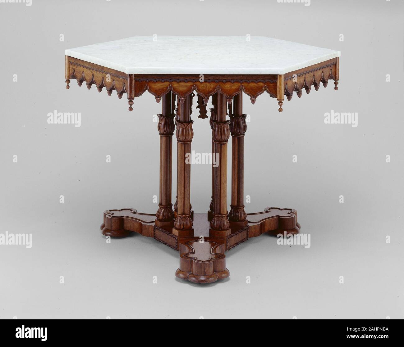 Alexander Roux. Belmead Center table. 1846. New York City. Rosewood, oak, walnut, marble In 1845 Alexander Jackson Davis designed Belmead, a magnificent Gothic Revival villa, for the prominent builder Philip St. George Cocke of Powhatan County, Virginia. In addition to designing Belmead’s exterior, Davis also designed furniture for the interior, notably a parlor set that included the side chairs (1998.565.1-2). The table descended in the Cocke family along with the parlor set and, remarkably, retains its original marble top and intricately carved tracery lantern. Fitted between the supporting Stock Photo