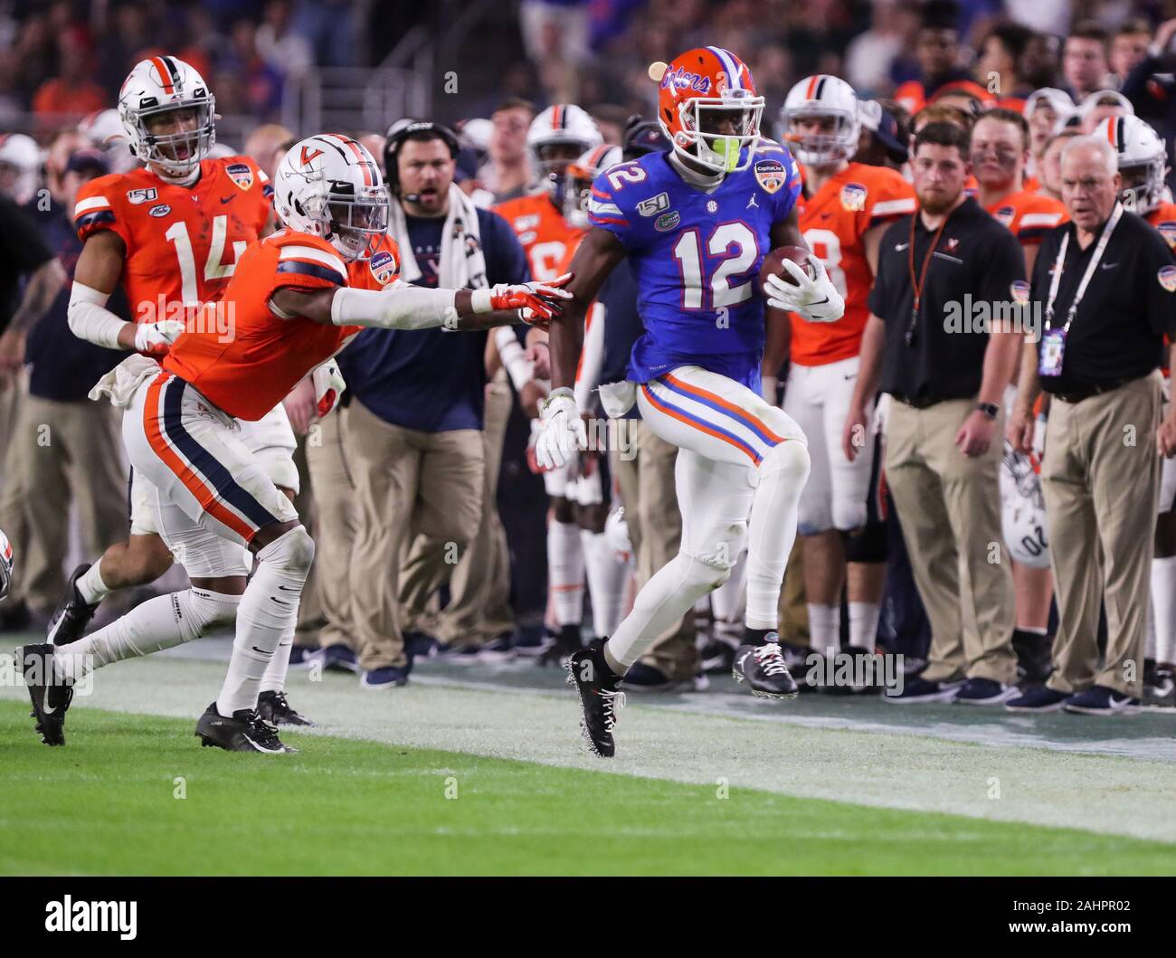 Miami Gardens, Florida, USA. 30th Dec, 2019. Florida Gators wide receiver Van Jefferson (12) running with the ball is pushed out-of-bounce by Virginia Cavaliers cornerback Nick Grant (1), left, during the Capital One Orange Bowl - NCAA Football game at the Hard Rock Stadium in Miami Gardens, Florida. Florida defeated Virginia 36-28. Mario Houben/CSM/Alamy Live News Stock Photo