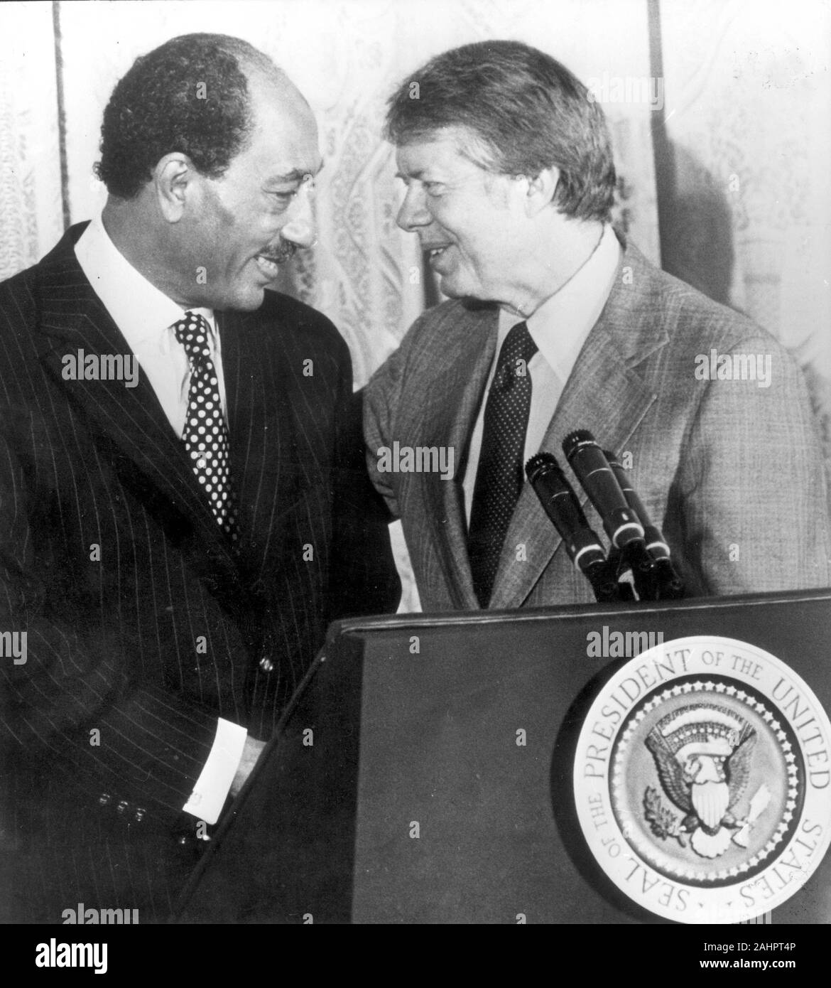 Apr 4, 1977 - Washington, District of Columbia, USA - JIMMY CARTER stands with Egyptian President ANWAR SADAT at a podium with the presidential seal. President Sadat is in town to continue peace terms conversation with President Carter.(Credit Image: © Keystone Press Agency/Keystone USA via ZUMAPRESS.com) Stock Photo