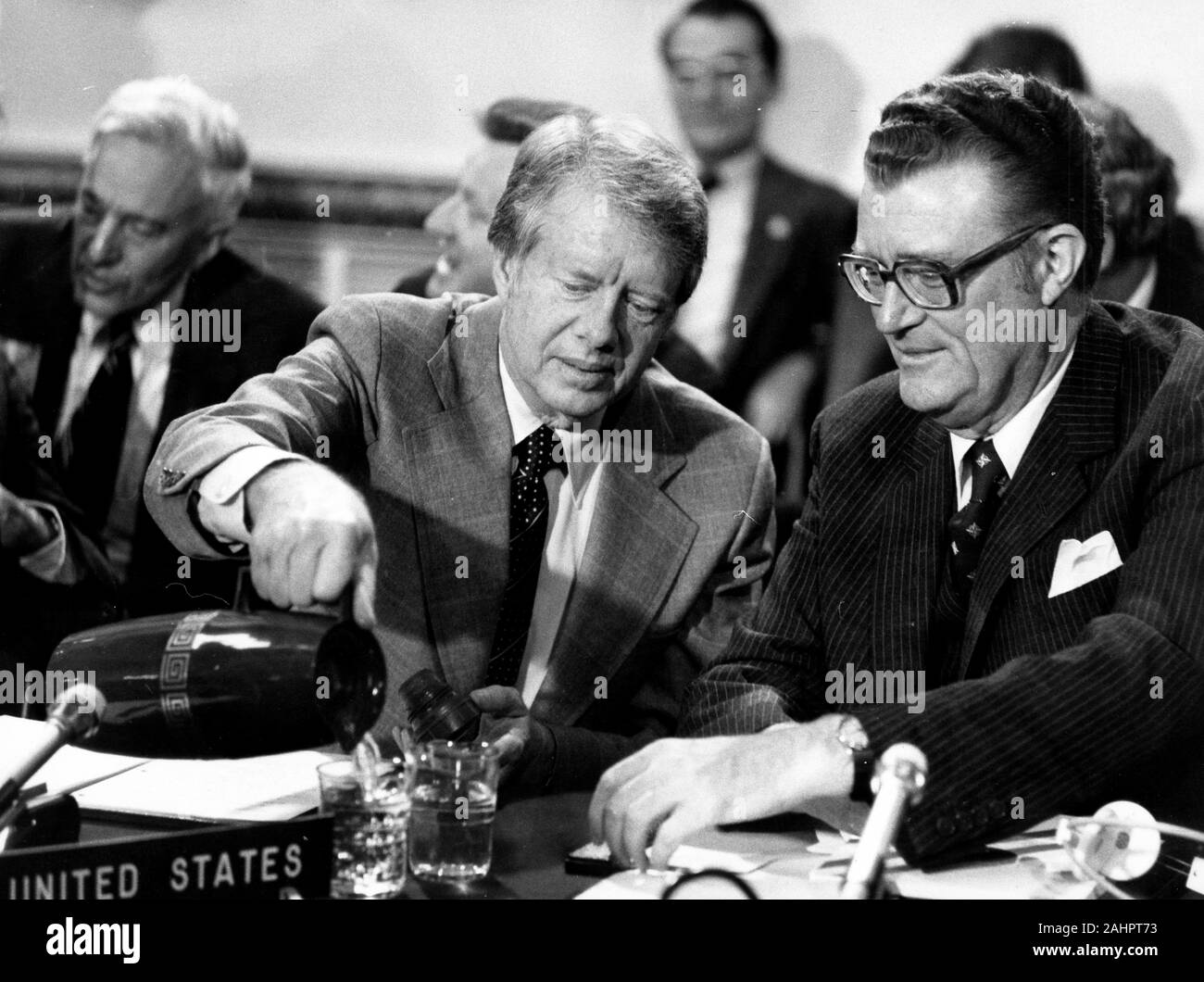 May 10, 1977 - London, England, United Kingdom - U.S. President JIMMY CARTER pours water for U.S. Permanent Representative to NATO TAPLEY BENNETT JR during the Ministerial meeting of North Atlantic Treaty Organization, NATO, London opening session at Lancaster House. Lancaster House (previously known as York House and Stafford House) is a mansion in the St. James's district in the West End of London (Credit Image: © Keystone Press Agency/Keystone USA via ZUMAPRESS.com) Stock Photo