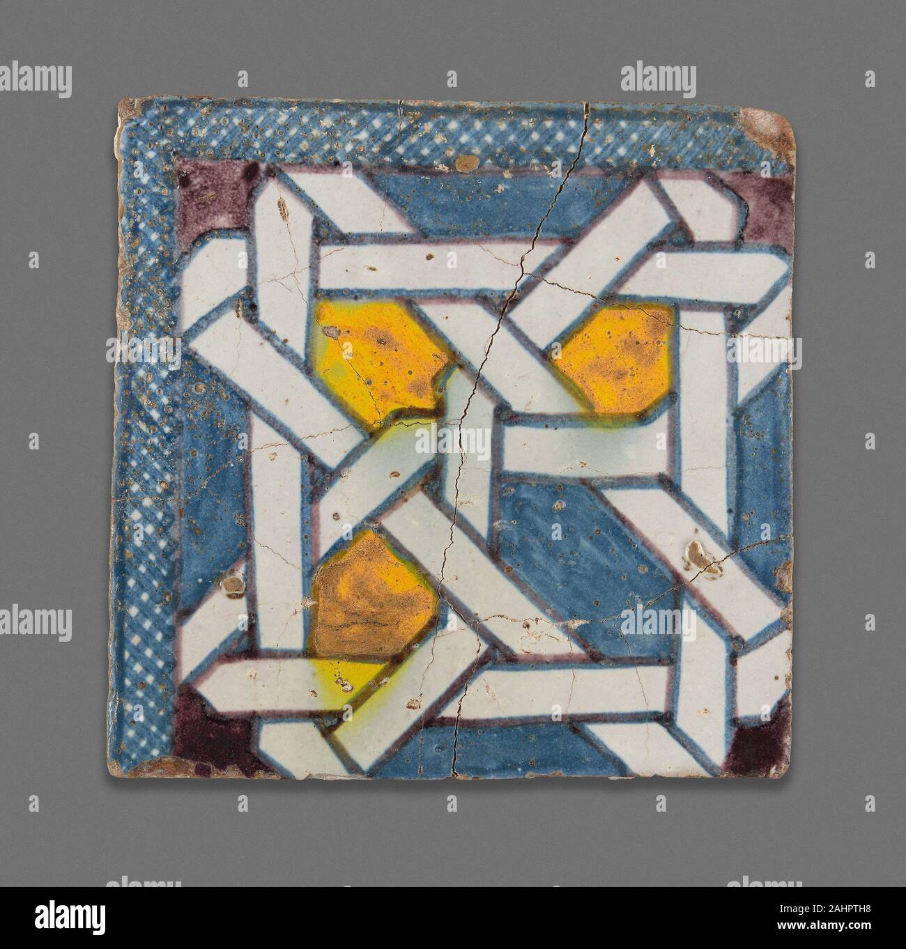 Square Tile. 1867–1899. Morocco. Poychrome pigment applied over opaque white glaze Geometric tilework comprised of individually cut pieces, or zillij, is a prominent feature of Moroccan architecture dating back more than 700 years. It is incredibly costly to make due to the skill involved in the design and layout of the mosaic. This imitation zillij tile achieves a similar effect while reducing the cost of labor and materials, and it speaks to the enduring importance of the zillij style as a highly prized art form in 19th-century Morocco. In an architectural context, numerous zilij tiles would Stock Photo