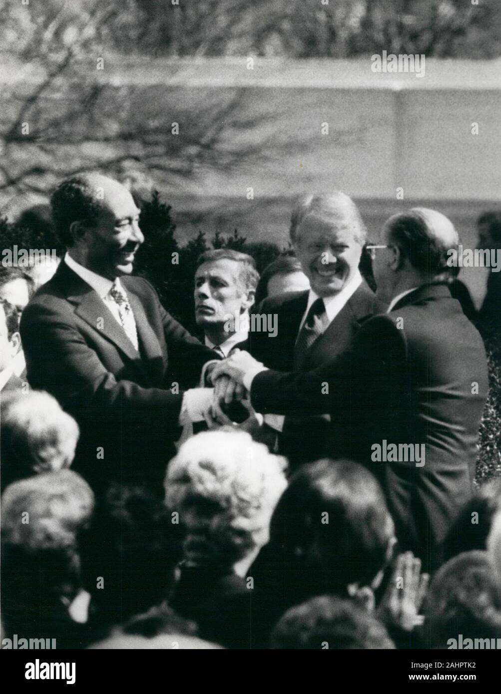 Mar 26, 1979 - Washington, District of Columbia, USA - Egyptian President ANWAR SADAT, standing left, with Israeli Prime Minister MENACHEM BEGIN, standing right, and US President JIMMY CARTER, center, pile their hands in a three way handshake after signing a peace treaty between Egypt and Israel. (Credit Image: © Keystone Press Agency/Keystone USA via ZUMAPRESS.com) Stock Photo