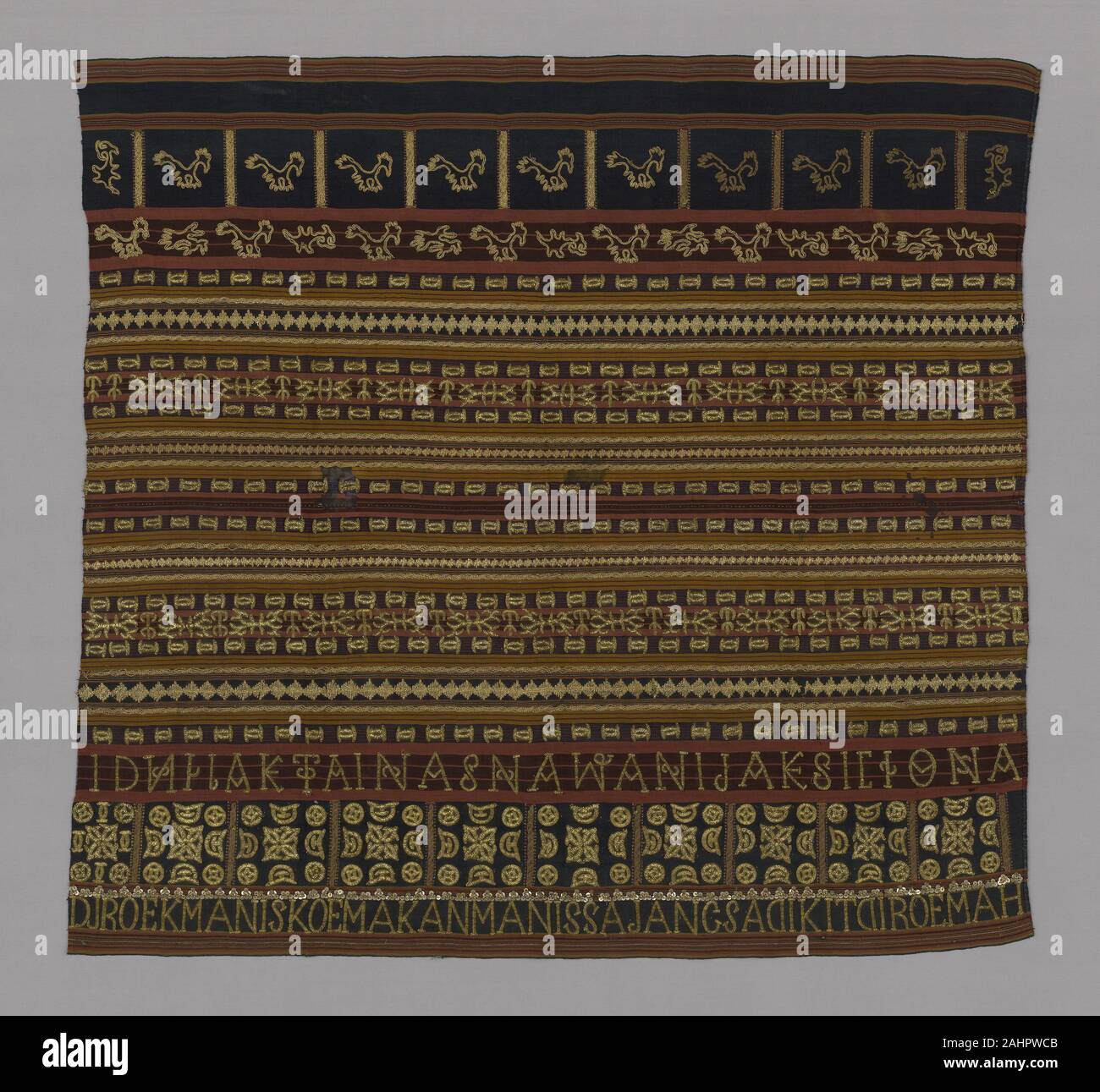 Abung. Woman's Ceremonial Skirt (Tapis). 1801–1900. Indonesia. Two panels joined cotton and silk, warp-faced, weft ribbed plain weave; embroidered with silk, gold-leaf-over-lacquered-paper strip wrapped cotton, cotton, gilt-metal coils, gilt-metal wire wrapped cotton ,gilt-metal-strip wrapped cotton and gilt-metal spangles in running stitches; laidwork, couching, and padded couching Stock Photo