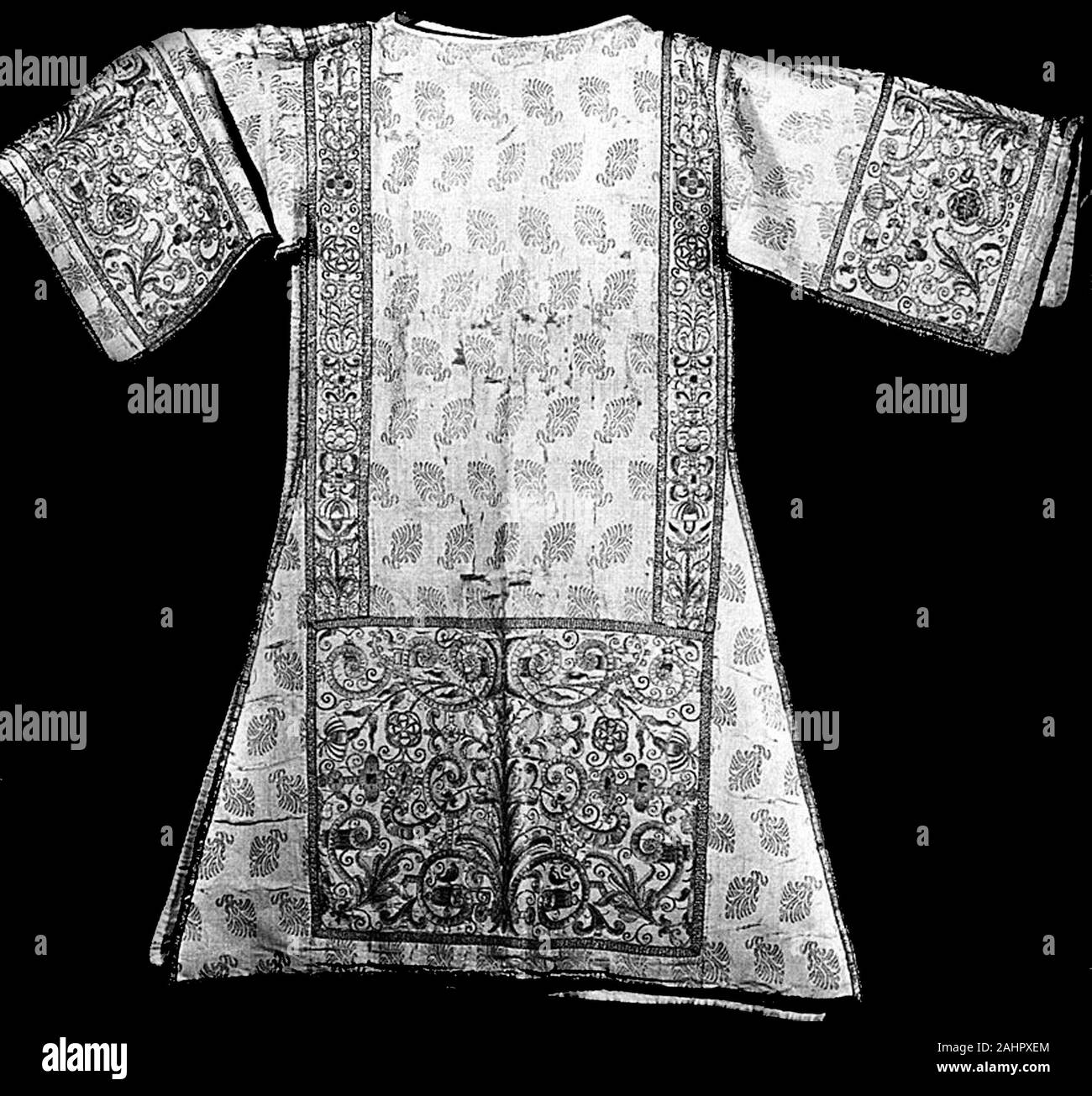 Dalmatic. 1601–1700. Spain. Silk and gilt-metal-strip-wrapped silk, plain weave with gilt-metal strip facing wefts and brocading wefts; apparels and orphrey bands silk, plain weave with gilt-metal strip facing wefts; embroidered with silk and gilt-metal-strip-wrapped silk and cotton in satin, split, raised stem, and stem stitches; couching; edged with woven fringe Stock Photo